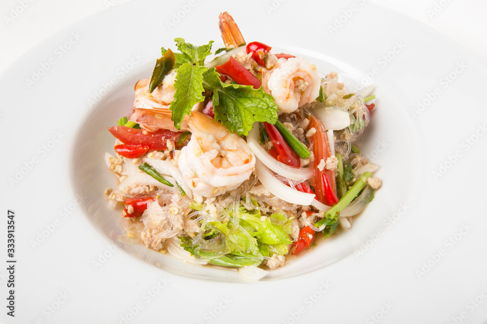 delicious spicy mixed seafood thai food made from shrimps squids minced pork kale chili and vegetable serve in white dish close up delicious spicy mixed seafood thai food made from shrimps squids minced pork kale chili and vegetable serve in white dish close up