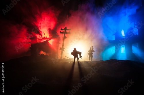 Military officer running out with woman from burned out city destroyed in war. Creative artwork decoration. Selective focus