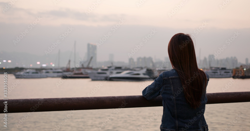 Woman look at the sea view in sunset time