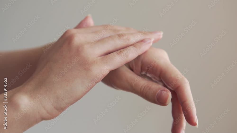 Clean well-groomed hands of a young woman applying hand cream Clean well-groomed hands of a young woman applying hand cream