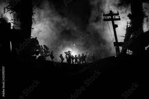 War Concept. Military silhouettes fighting scene on war fog sky background, World War Soldiers Silhouette Below Cloudy Skyline At night. photo