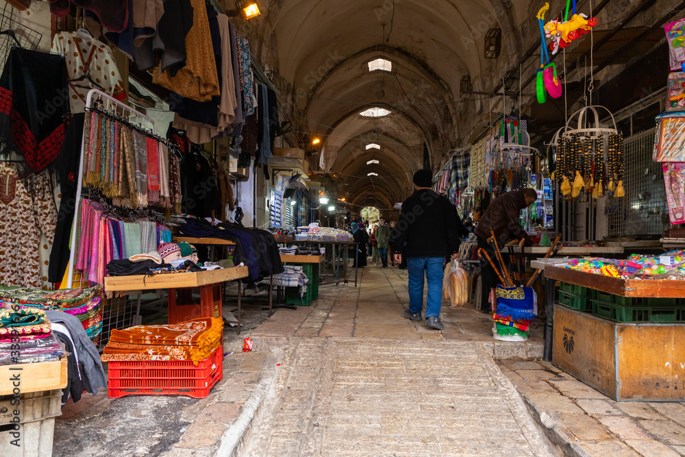 A street with shops selling fabrics and souvenirs leads from the Arab market to the Bab al-Qattaneen - Gate of the Cotton Merchantsis of the Temple Mount in Jerusalem in Israel