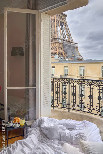 Photography Window view of the Eiffel Tower with breakfast in a bed