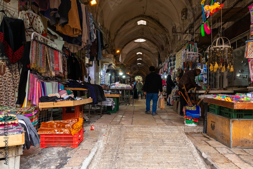 A street with shops selling fabrics and souvenirs leads from the Arab market to the Bab al-Qattaneen - Gate of the Cotton Merchantsis of the Temple Mount in Jerusalem in Israel