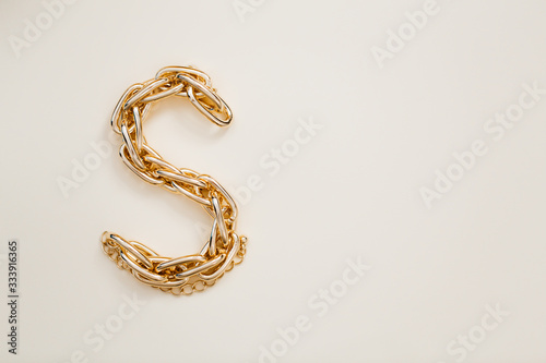 massive golden braided chain bracelet on a white background in isolation copy space place text
