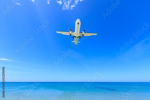 Passenger airplane landing to airport above Mai Khao Beach. Famous place location for plane spotter and tourists, Phuket, Thailand