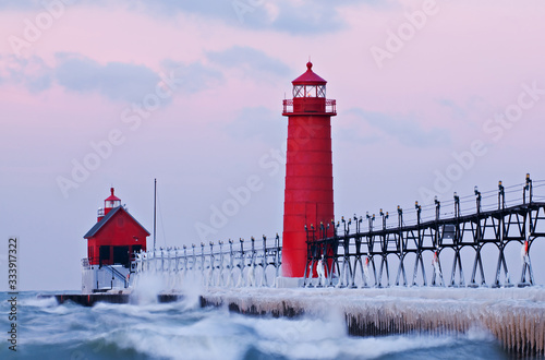 Winter landscape of the Grand Haven Lighthouse, pier, and catwalk at dawn, Lake Michigan, Michigan, USA photo