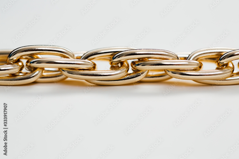 massive golden braided chain bracelet on a white background in isolation copy space place text massive golden braided chain bracelet on a white background in isolation copy space place text