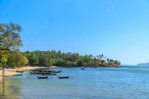 Crystal clear turquoise blue sea at Rawai Beach and fisherman village with fishing boat, Phuket, Thailand © wirojsid