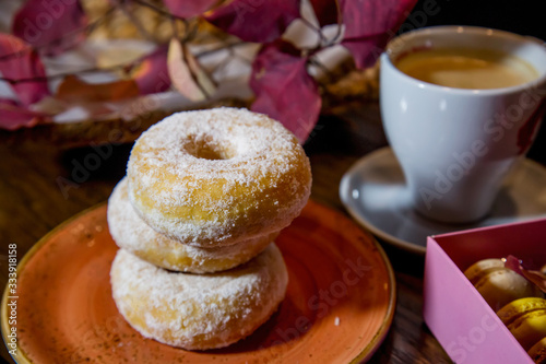 cup of coffee and donuts on table