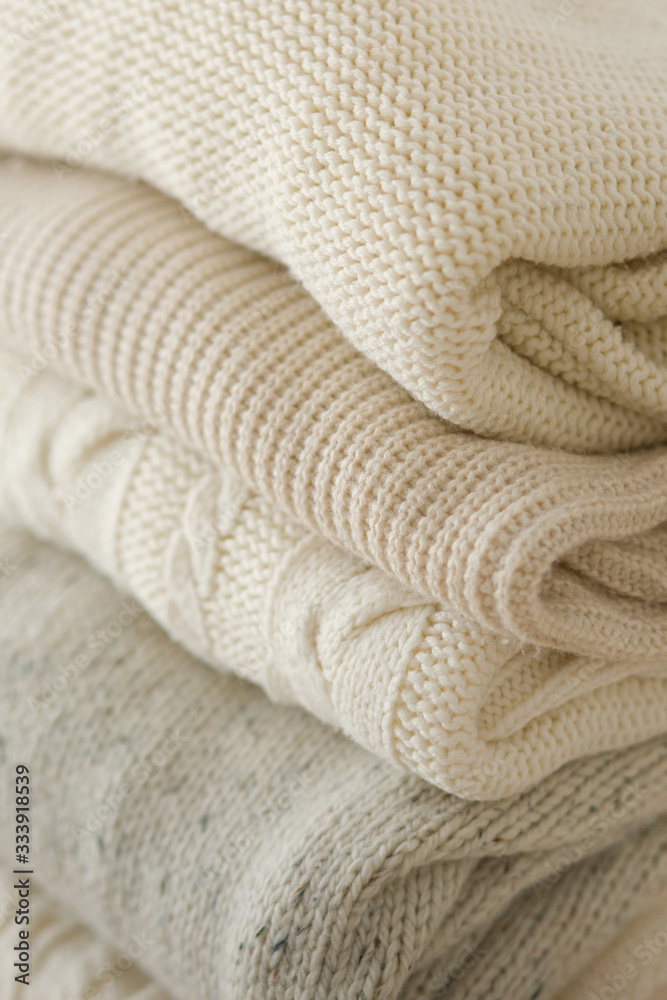 Stock Photo - Stack of cozy knitted sweaters Stock Photo - Stack of cozy knitted sweaters