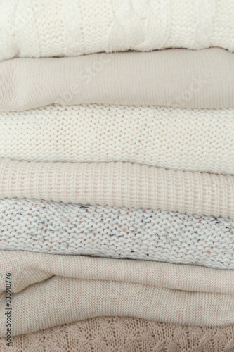 Stock Photo - Stack of cozy knitted sweaters