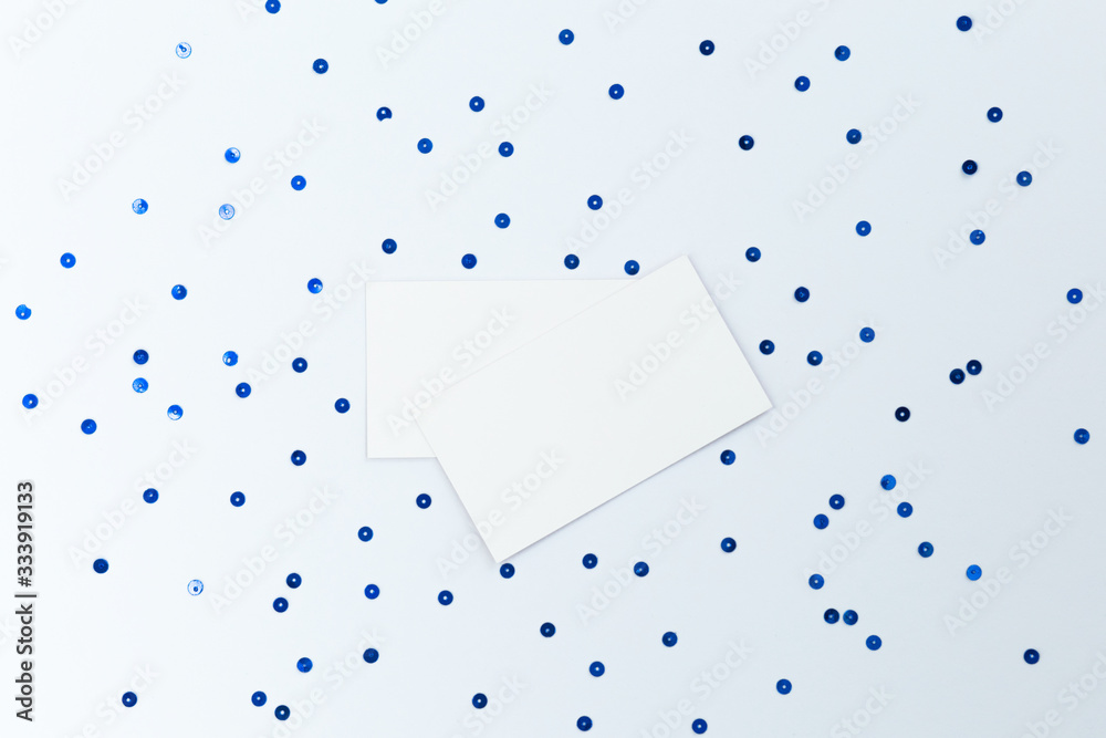 Stock Photo - Photo of blank card with blue sequins on paper background. For design presentations and portfolios. Stock Photo - Photo of blank card with blue sequins on paper background. For design presentations and portfolios.