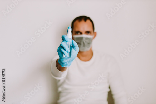 man using liquid hand sanitizer during quarantine at home