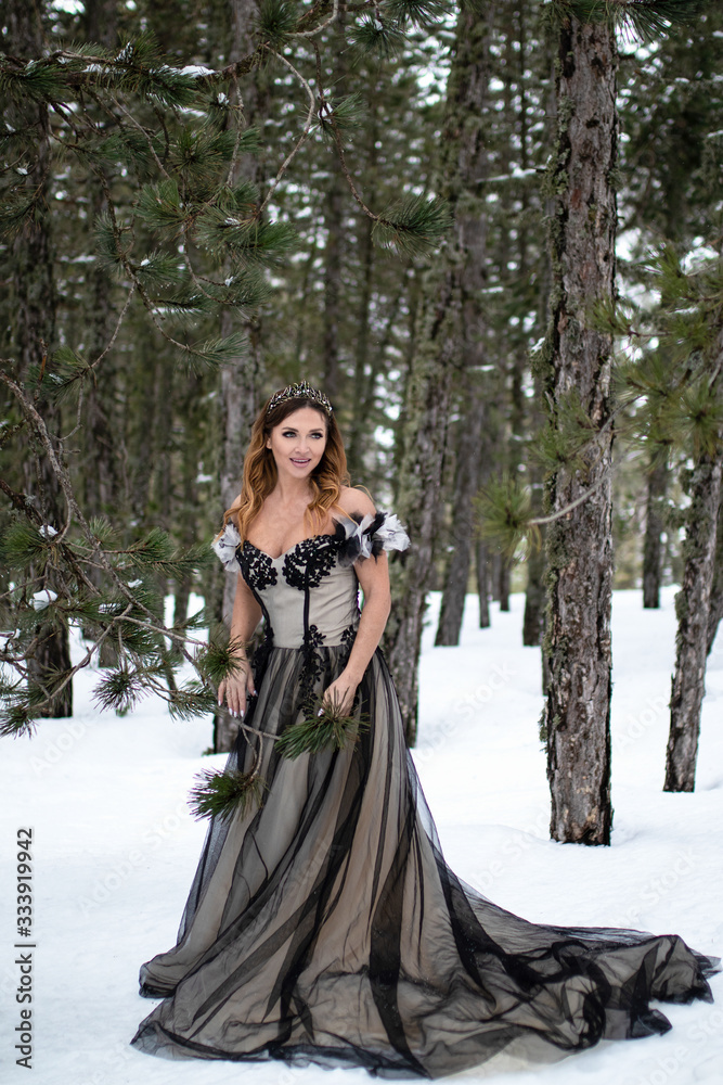 Model cosplay Snow Queen outdoor in winter pine forest Model cosplay Snow Queen outdoor in winter pine forest