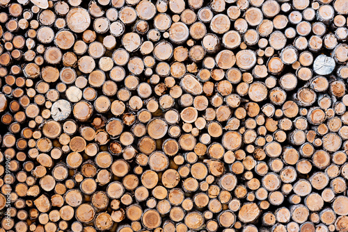 Woodpile in stack. Circle shape. Wall of firewood. Retro filtered. Vintage style.