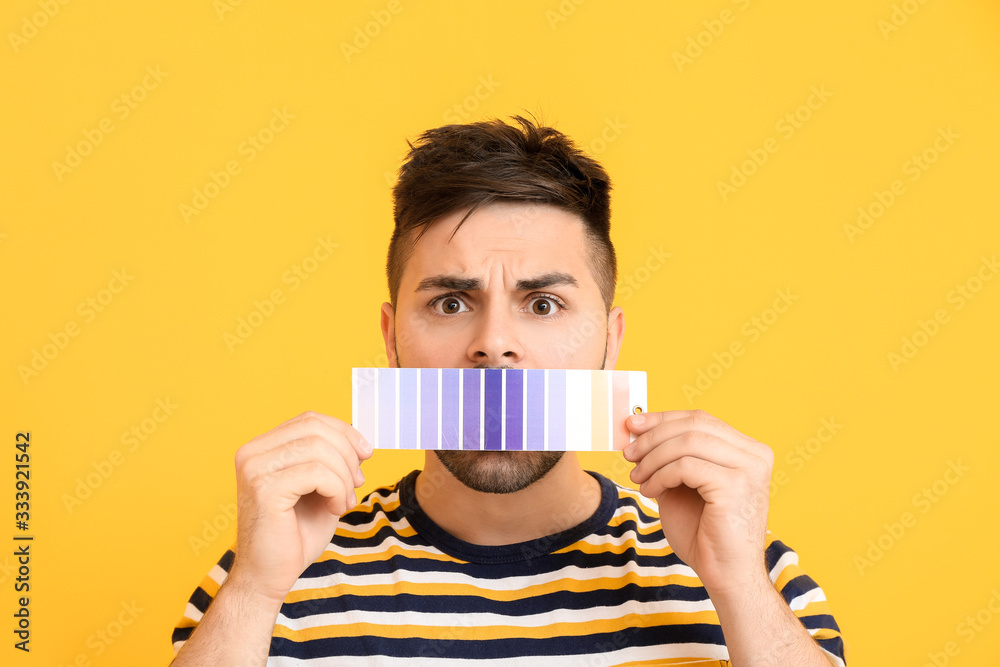 Troubled man with paint palette on color background Troubled man with paint palette on color background