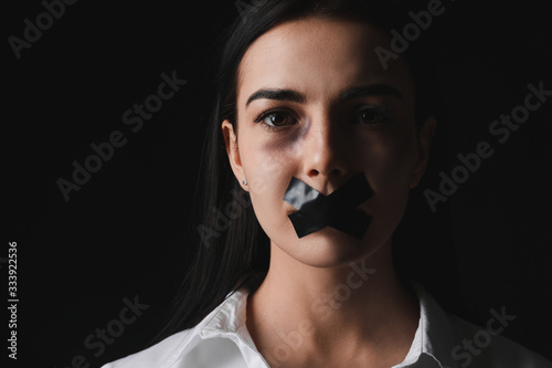 Scared female victim with t...