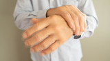 Parkinson's disease symptoms. Close up of tremor (shaking) hands of senior man patient with Parkinson's disease. Mental health and neurological disorders concept.