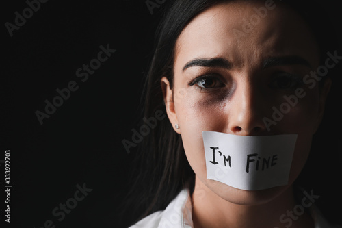 Scared female victim with t...