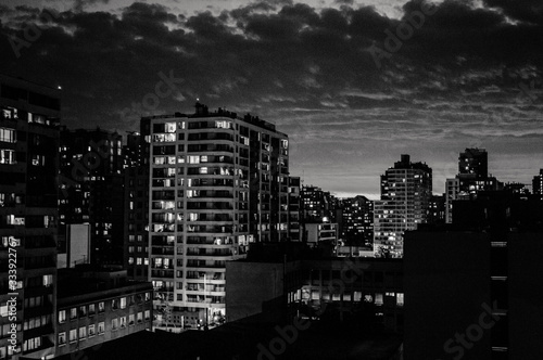 Ciudad de noche en blanco y negro, atardecer con nubes