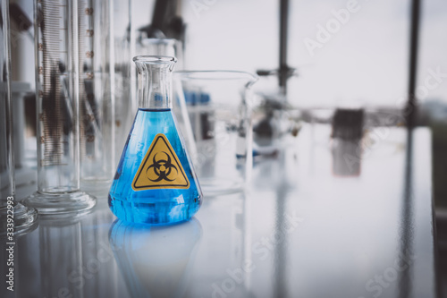 Yellow Biohazzard sign on Chemical Glassware in Lab photo