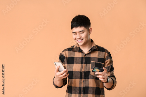 Asian man with credit card ...