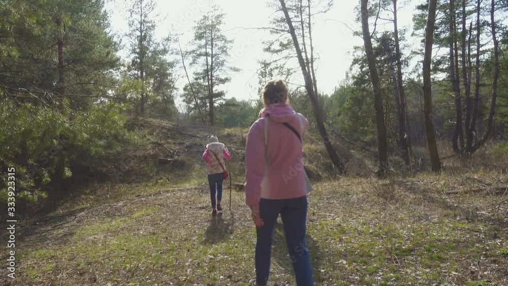 mother with two daughters walking by the forest at the sunny spring day mother with two daughters walking by the forest at the sunny spring day