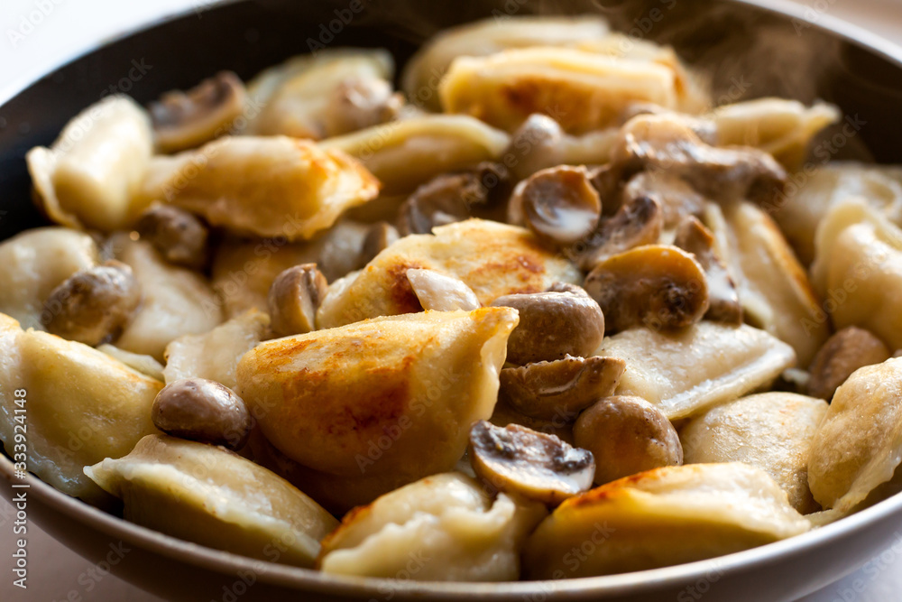 homemade fried dumplings with mushrooms in a pan homemade fried dumplings with mushrooms in a pan