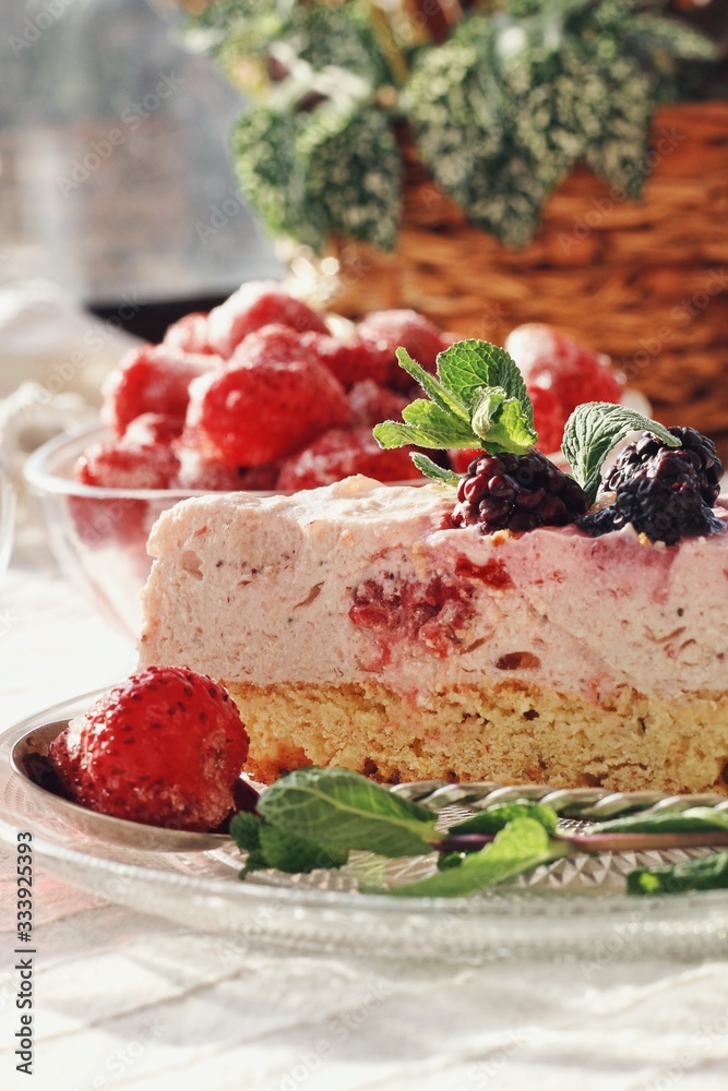 Fresh delicious dessert with berries and green decoration, sweet food, tea time, close up