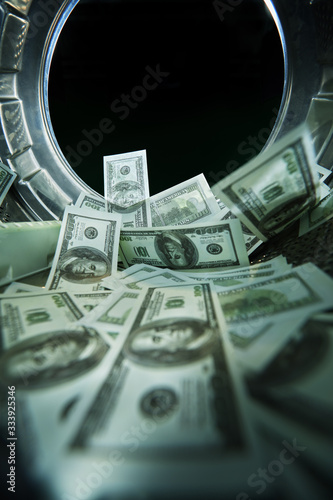 Washing banknotes in machine, money laundering, financial fraud concept
