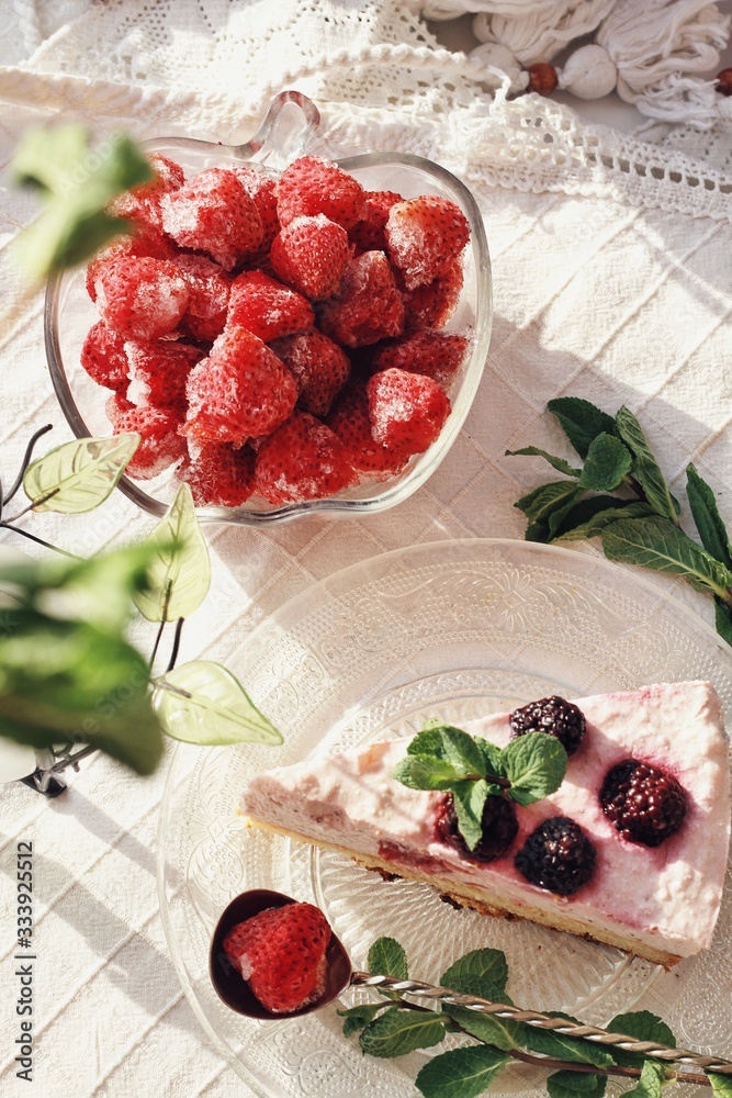 Fresh delicious dessert with berries and green decoration, sweet food, tea time, top view