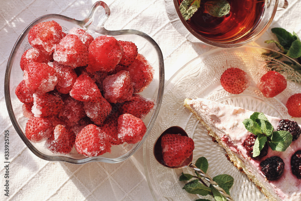 Fresh delicious dessert with berries and green decoration, sweet food, tea time, top view