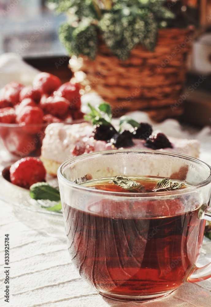 Fresh delicious dessert with berries and green decoration, sweet food, tea time, focused on tea