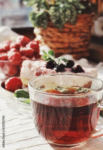 Obraz na płótnie Fresh delicious dessert with berries and green decoration, sweet food, tea time, focused on tea w salonie