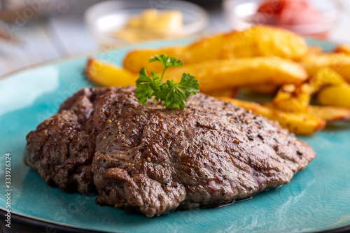 steak on a plate with french fries