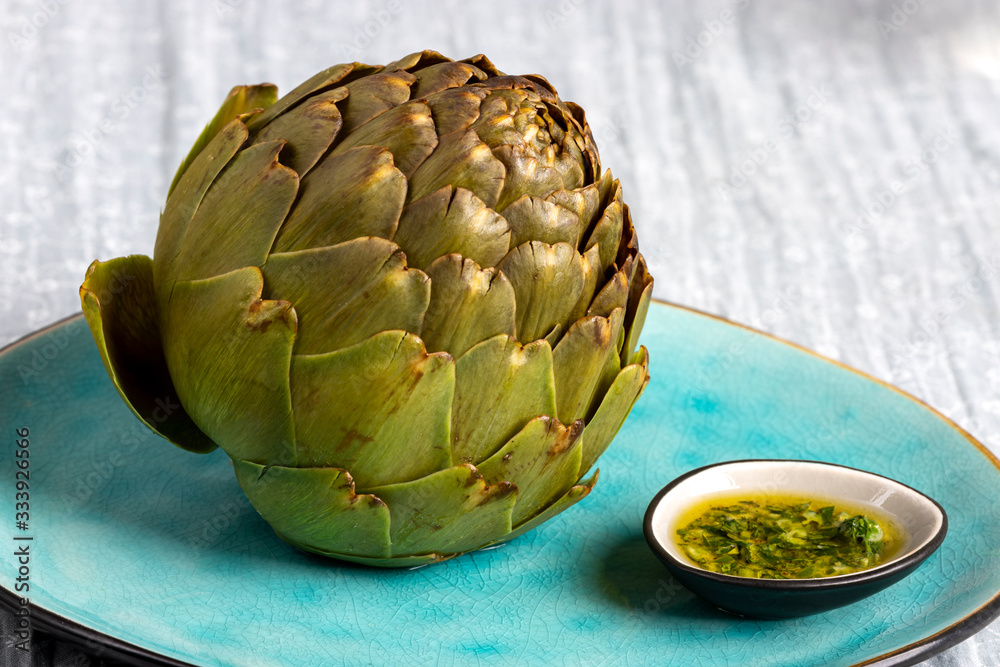 Obraz premium cooked artichoke on a blue plate
