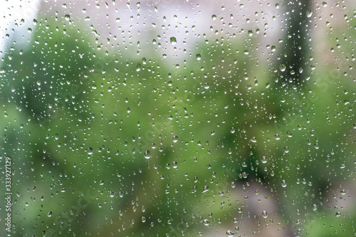 Drops of rain on the window with sky background