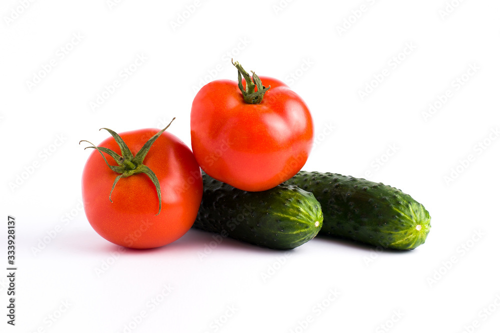 Red tomato garlic and cucumber on a white background.Fresh vegetables on a white background. cucumber and tomato on a white background Red tomato garlic and cucumber on a white background.Fresh vegetables on a white background. cucumber and tomato on a white background