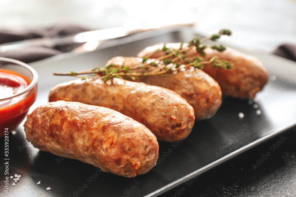 Plate with tasty grilled sausages on table, closeup Plate with tasty grilled sausages on table, closeup