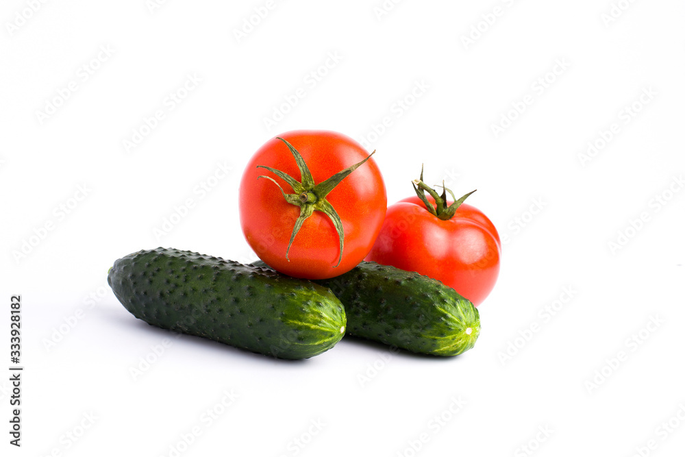 Red tomato garlic and cucumber on a white background.Fresh vegetables on a white background. cucumber and tomato on a white background Red tomato garlic and cucumber on a white background.Fresh vegetables on a white background. cucumber and tomato on a white background