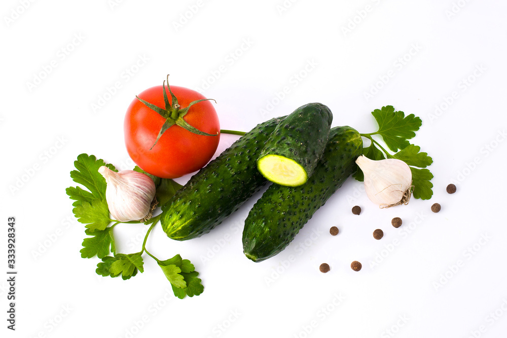 Red tomato garlic and cucumber on a white background.Fresh vegetables on a white background. cucumber and tomato on a white background Red tomato garlic and cucumber on a white background.Fresh vegetables on a white background. cucumber and tomato on a white background
