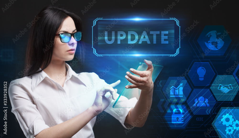 Business, Technology, Internet and network concept. Young businessman working on a virtual screen of the future and sees the inscription: Update Business, Technology, Internet and network concept. Young businessman working on a virtual screen of the future and sees the inscription: Update