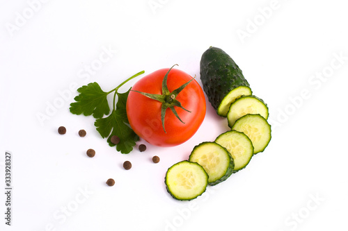 Red tomato garlic and cucumber on a white background.Fresh vegetables on a white background. cucumber and tomato on a white background