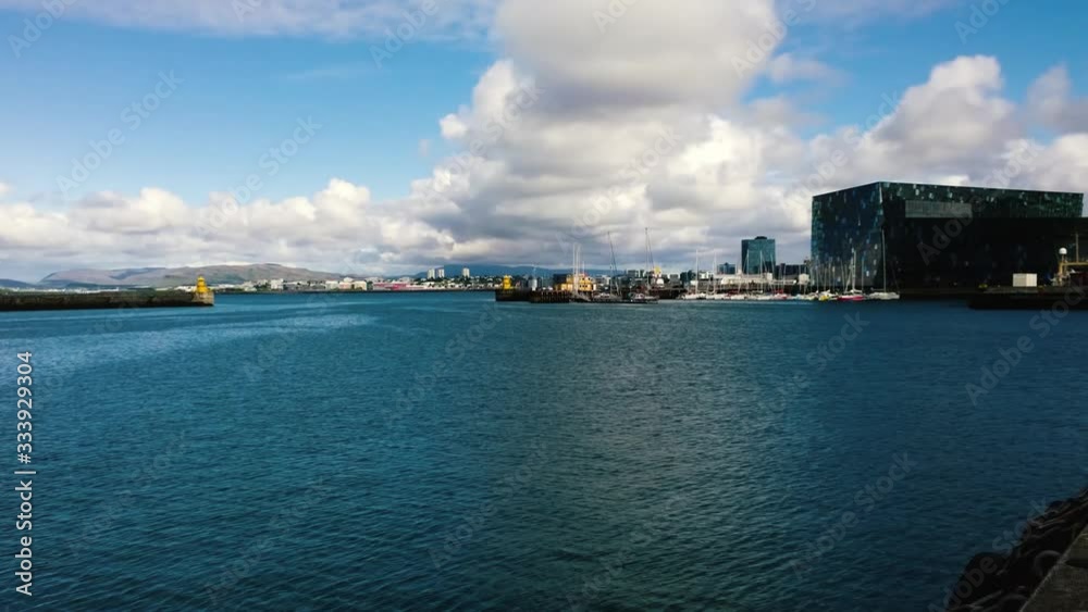 Time lapse of boats and ships arriving and leaving from the main harbor area of Reykjavik, the Capital city of Iceland. The clouds roll across the harbor on a sunny day. Time lapse of boats and ships arriving and leaving from the main harbor area of Reykjavik, the Capital city of Iceland. The clouds roll across the harbor on a sunny day.
