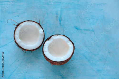 top view coconut halves on a blue background