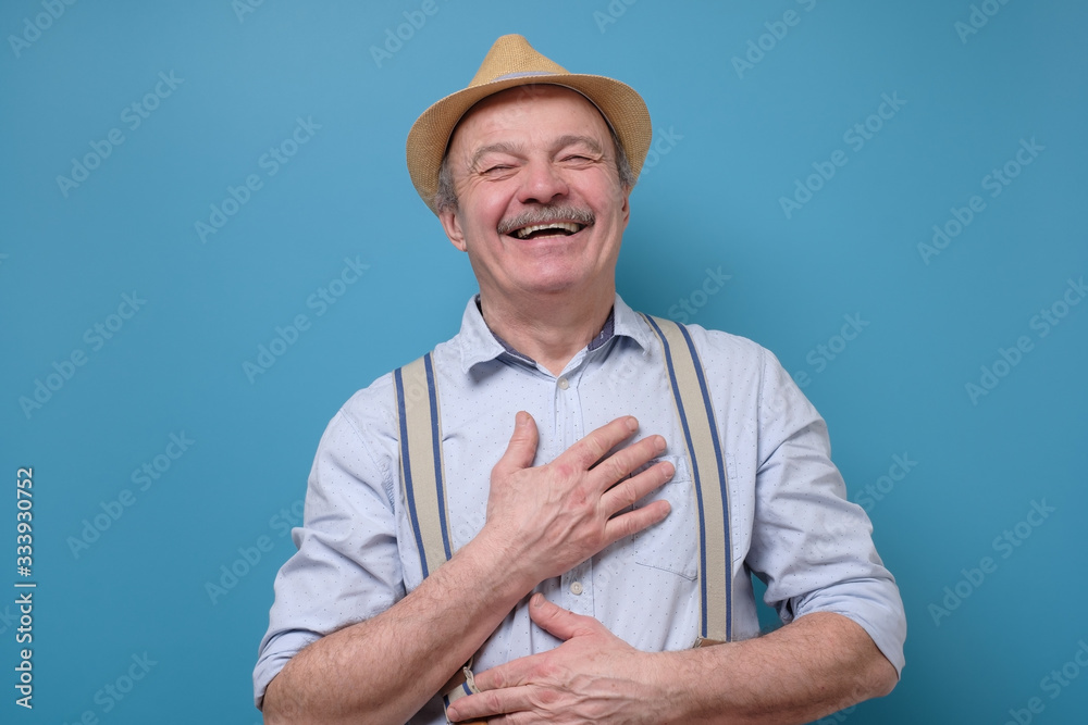 Laughing positive spanish senior handsome man having great mood feeling positiv Laughing positive spanish senior handsome man having great mood feeling positiv