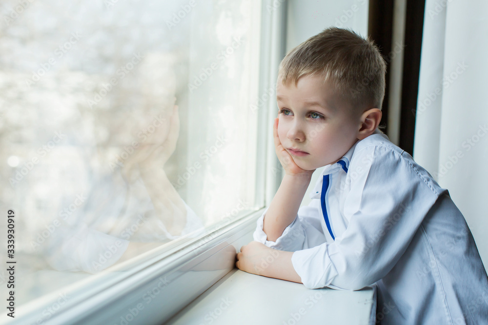 quarantine, a boy looks out the window quarantine, a boy looks out the window