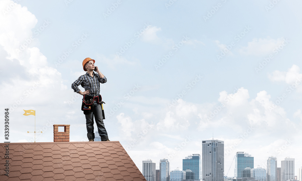 Attractive woman in workwear and hardhat Attractive woman in workwear and hardhat