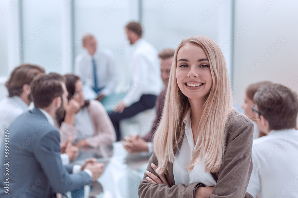 close up. smiling young employee standing in the office close up. smiling young employee standing in the office